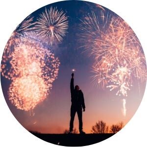 Person Standing in the Open with Fireworks in the Background