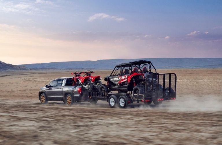 Gray 2021 Honda Ridgeline Rear Exterior Towing a Trailer in a Desert