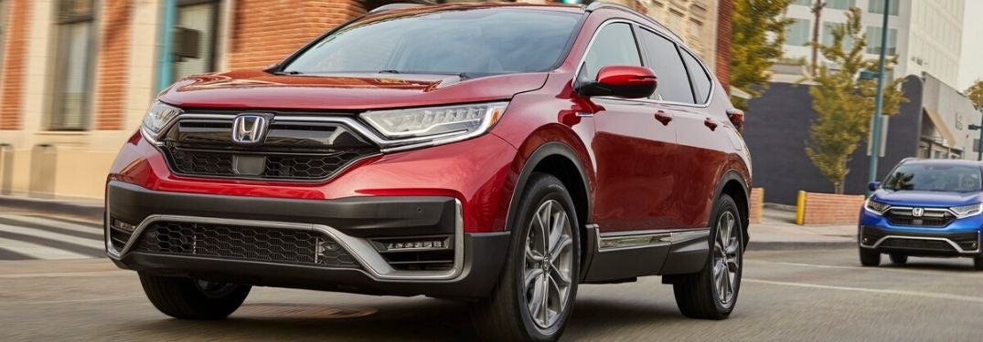 Red and Blue 2020 Honda CR-V Hybrid Models on a City Street