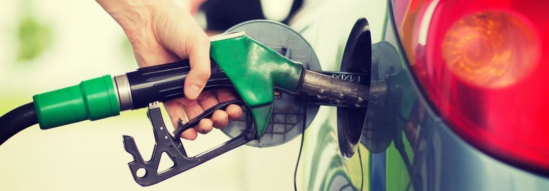 Green Fuel Pump Filling Up a Car