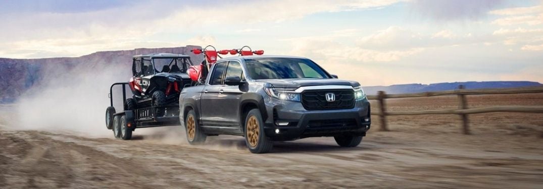 Gray 2021 Honda Ridgeline in a Desert Towing a Trailer with UTV