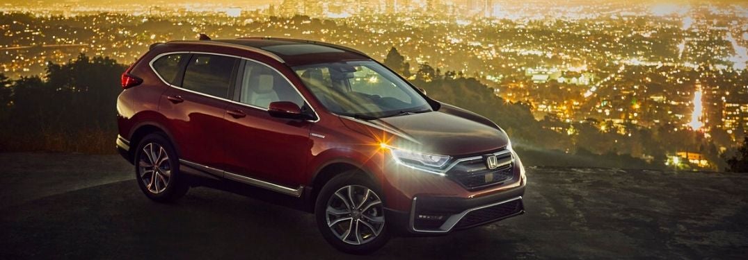 Red 2020 Honda CR-V Hybrid with City Skyline in Background at Night