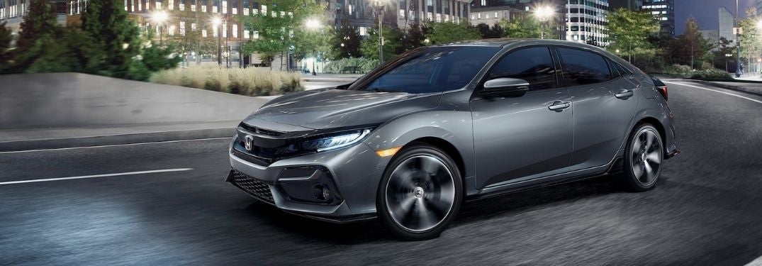 Gray 2021 Honda Civic Hatchback on a City Street at Night