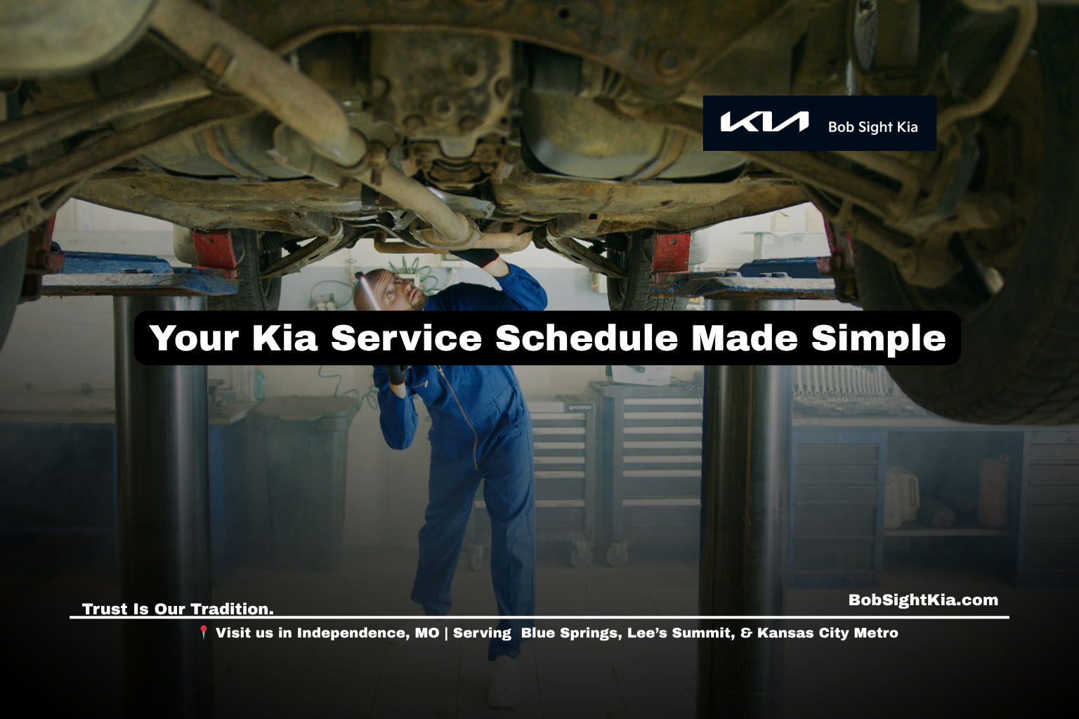 Kia service technician inspecting a vehicle at Bob Sight Kia in Independence Missouri.