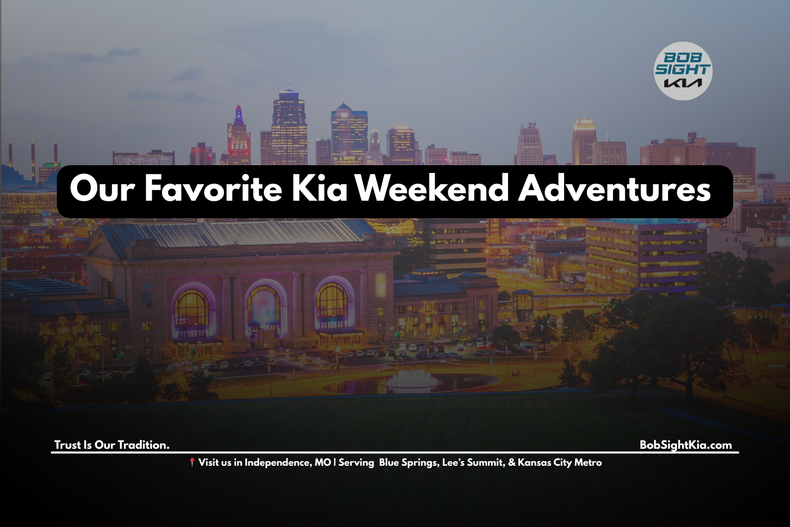 View from Kia SUV driving near a scenic Kansas City landmark on a sunny day.