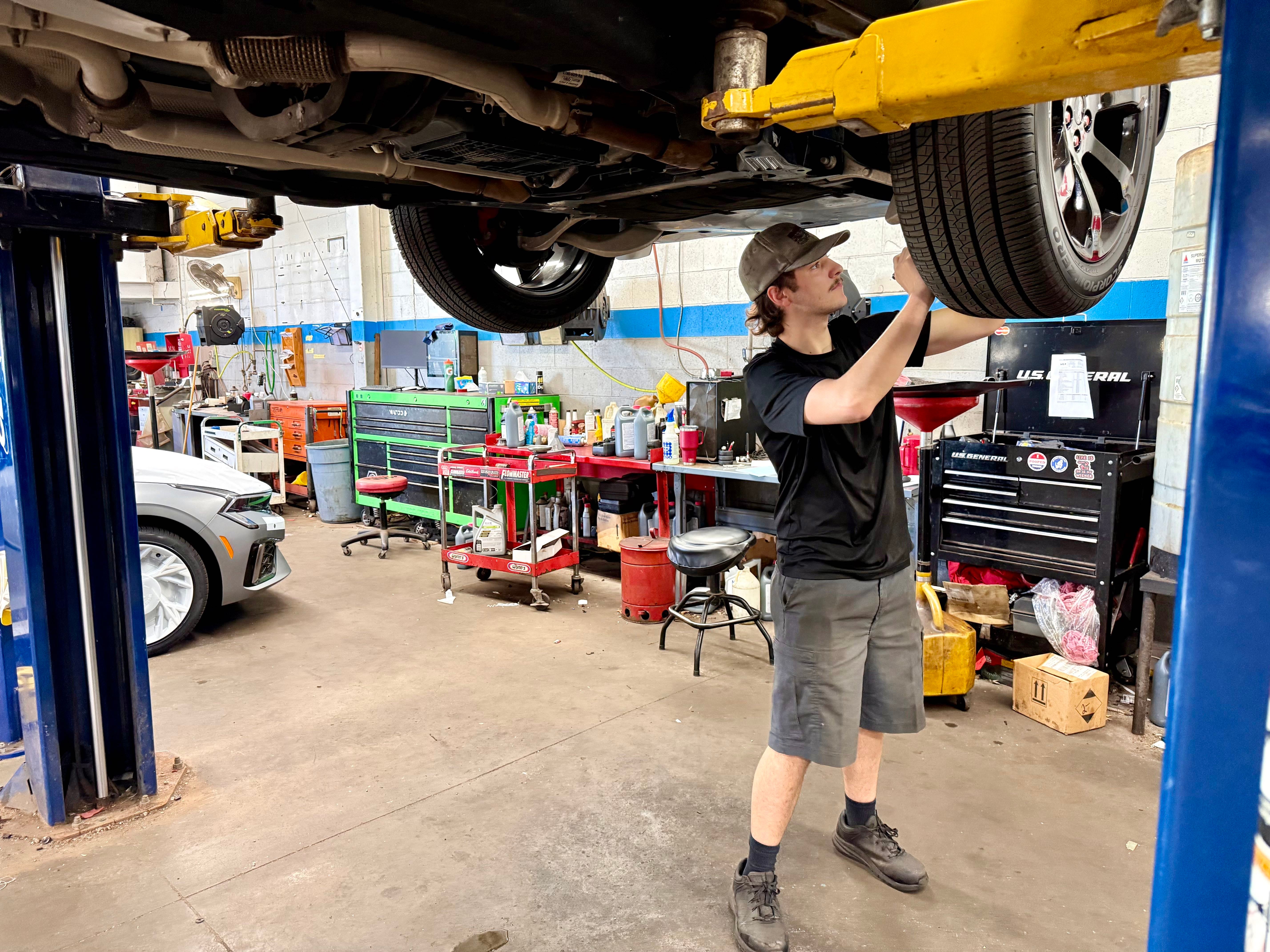 Kia technician inspecting vehicle at Bob Sight Kia Independence MO