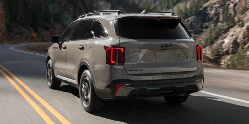 A photo of a 2025 Kia Sorento driving down the road.