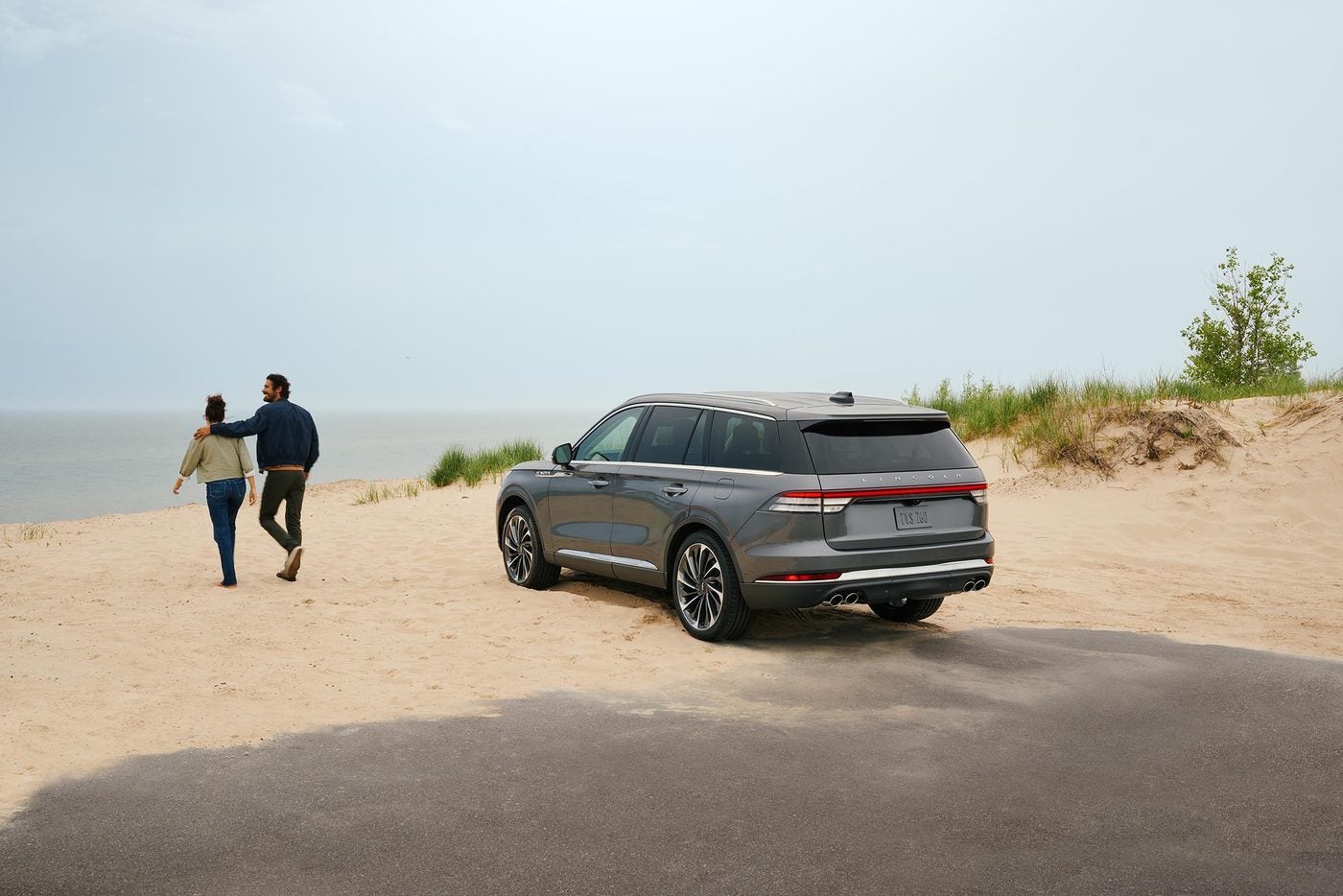 2027 Lincoln Aviator parked lakeside while a couple walks the shore, Granbury TX