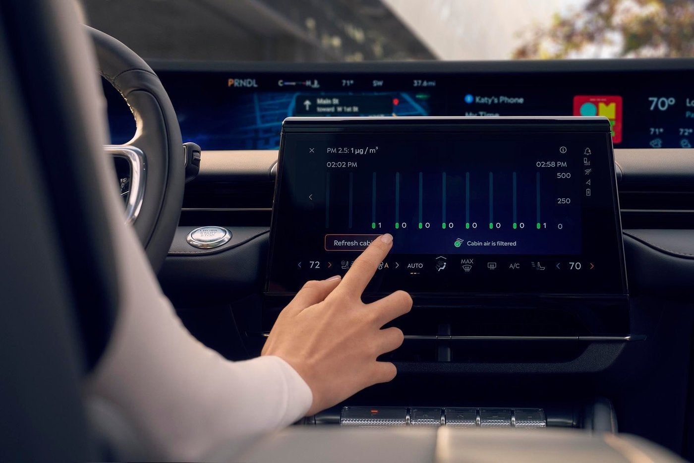 Hand using the center touchscreen in a Lincoln Nautilus Hand using the center touchscreen in a Lincoln Nautilus