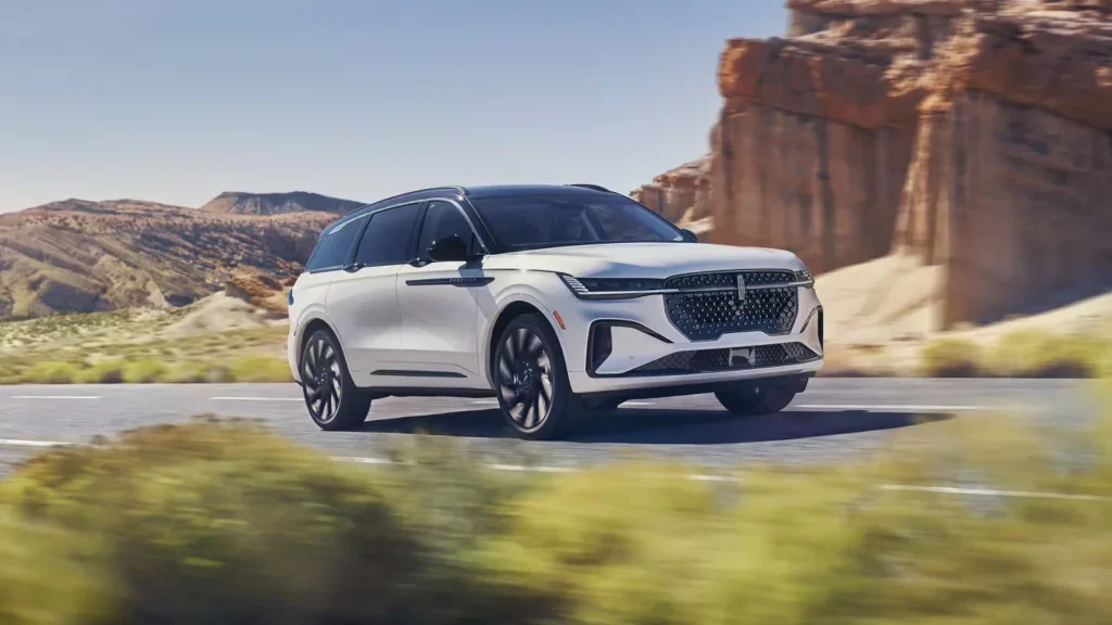 A 2025 Lincoln Black Label Nautilus® driving through a scenic desert highway.