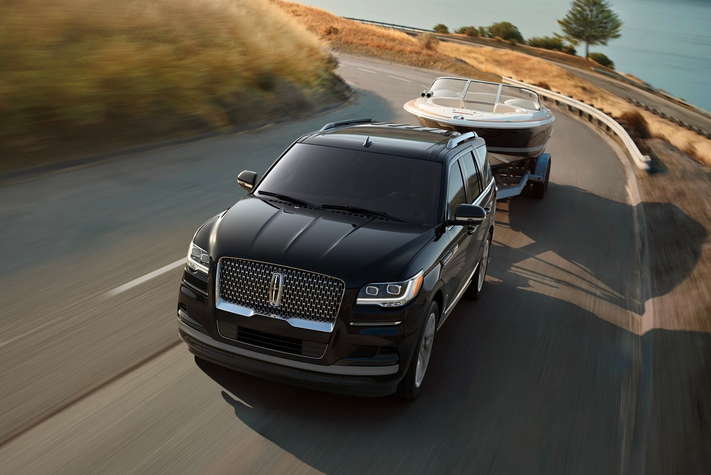 black lincoln navigator hauling a boat