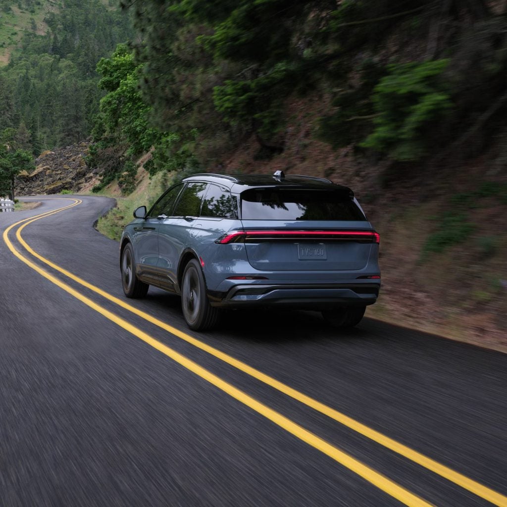 blue lincoln nautilus driving on the road