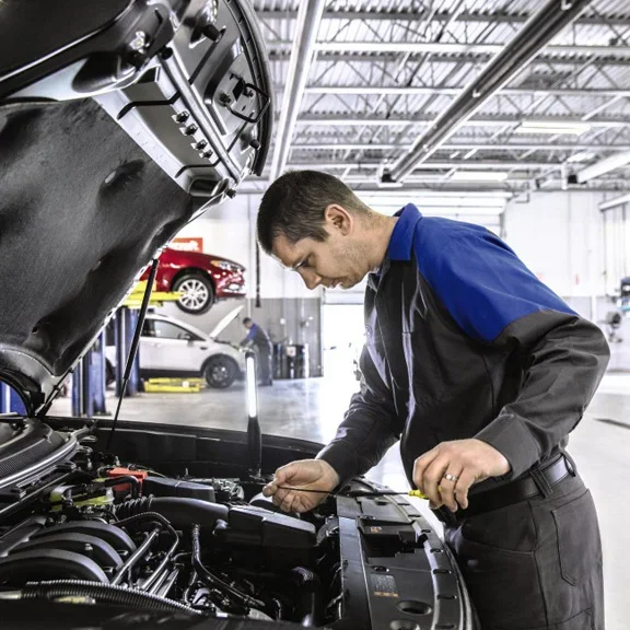 Technician checking oil level