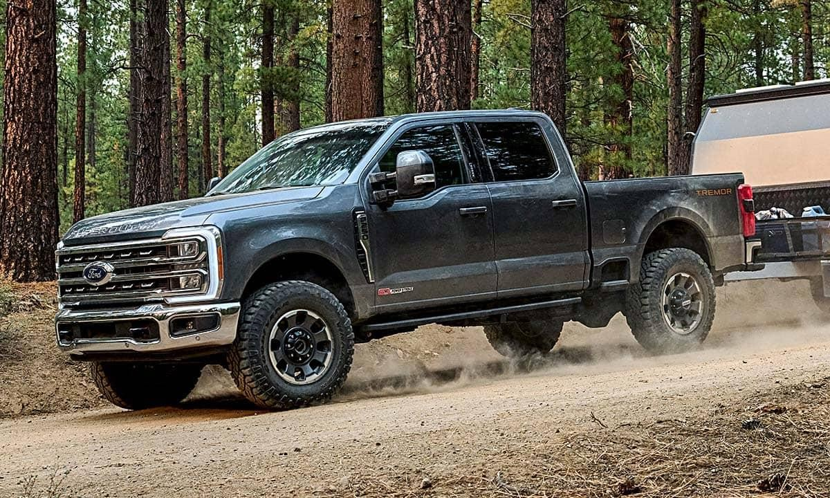 2027 Ford Super Duty pulling a trailer on a dirt road