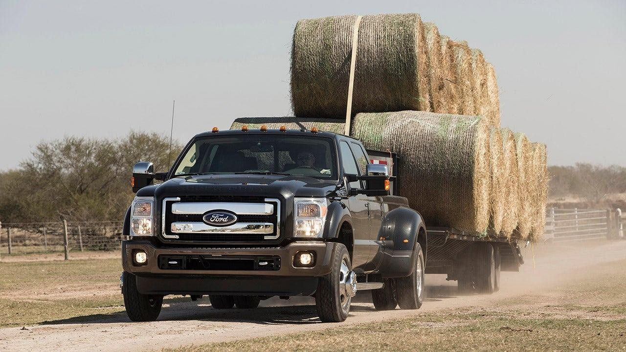 2027 Ford Super Duty Diesel pull a double decker trailer of rolled hay.