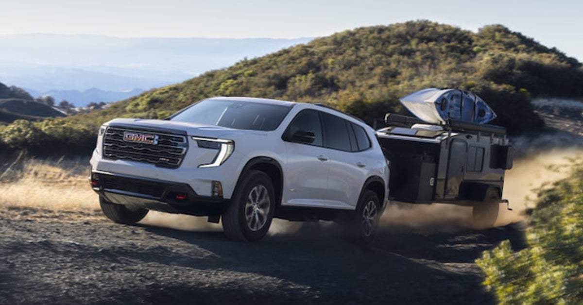 2025 GMC Acadia towing a trailer uphill