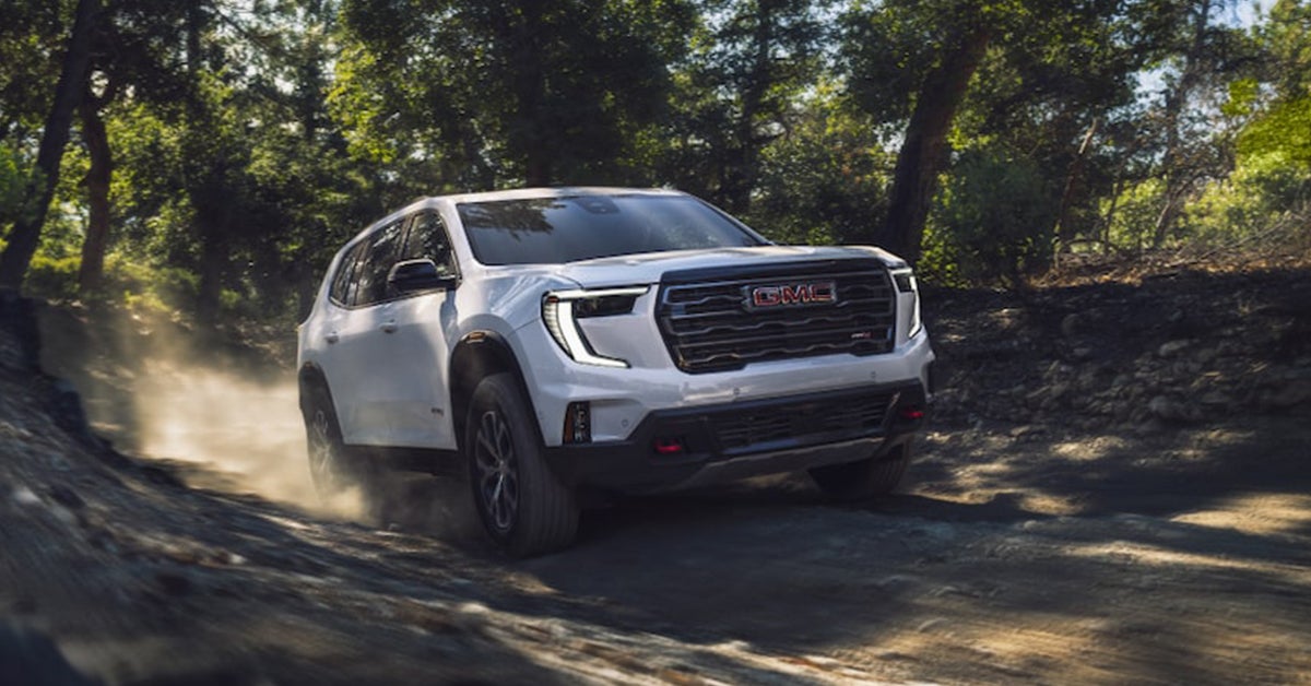 2025 GMC Acadia driving through a dirt path