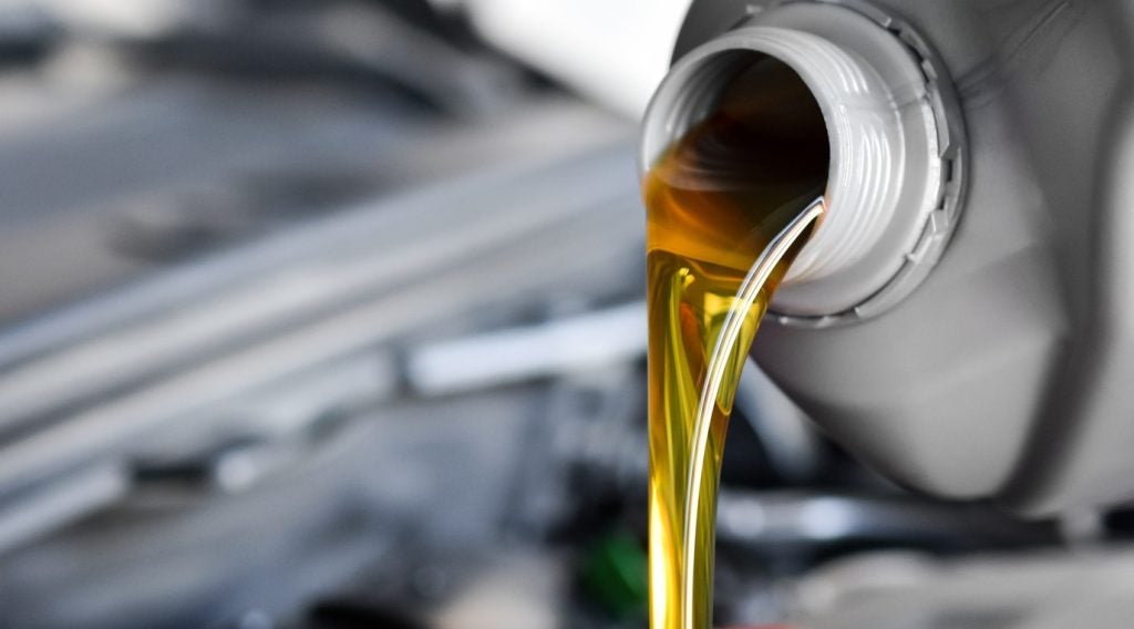 Motor Oil being poured into the engine of a vehicle.