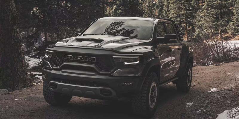 A photo of a 2024 RAM 1500 TRX driving down a winter trail