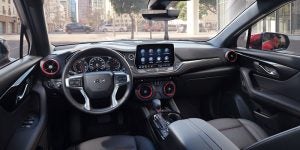 Interior view of a Chevrolet vehicle showing steering wheel, dashboard, and infotainment screen
