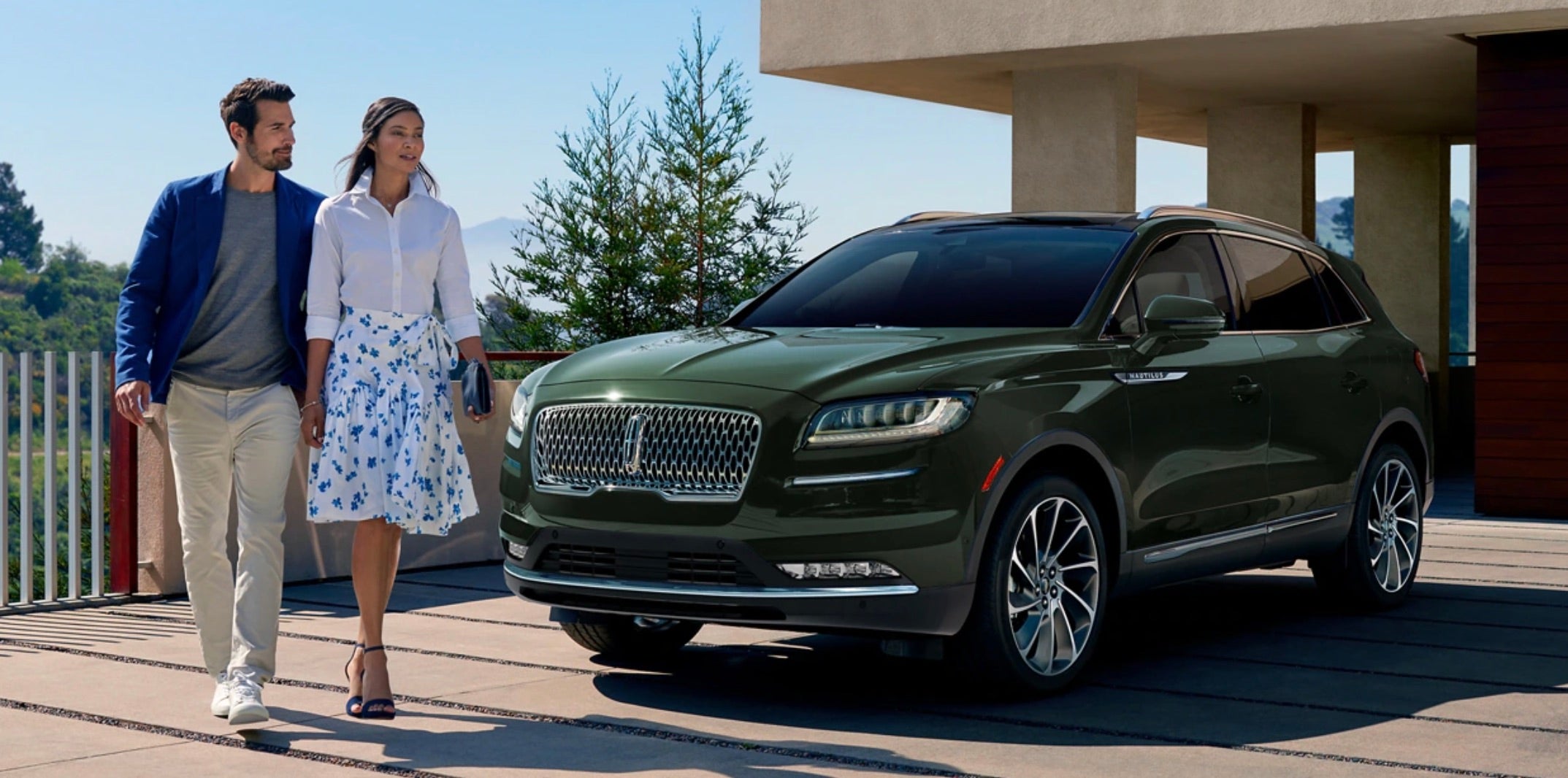 Couple walking away from 2022 Nautilus parked in their drive way.