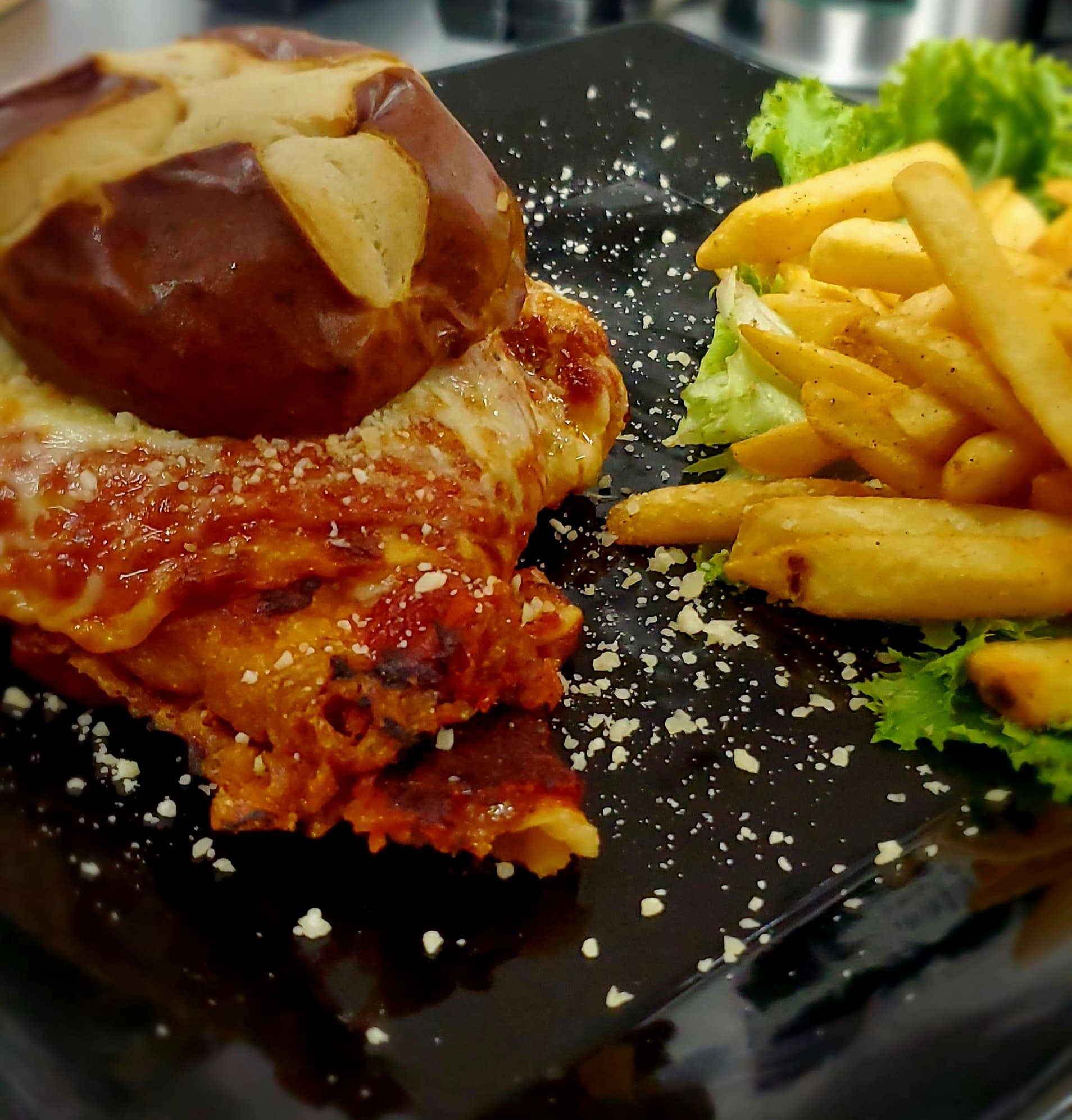 Delicious Hot Honey Fried Chicken Sandwich served with crispy golden fries on the side, showcasing a perfectly stacked sandwich with fresh ingredients and a flavorful glaze.