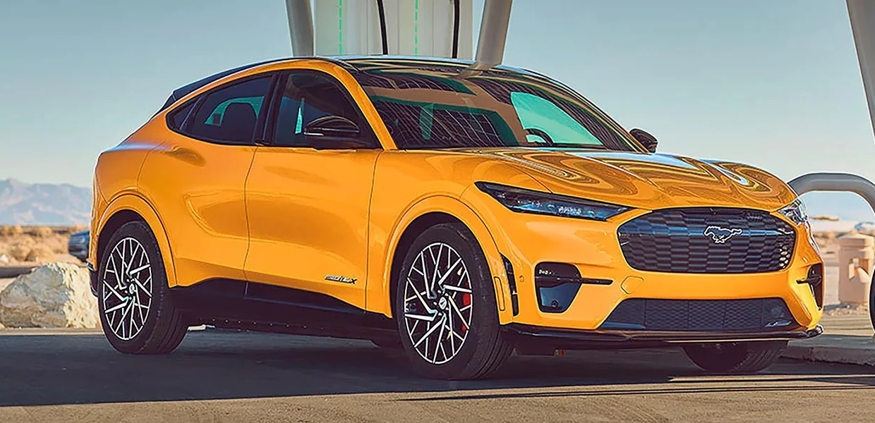 A 2023 Ford Mustang Mach-E plugged into a charging station