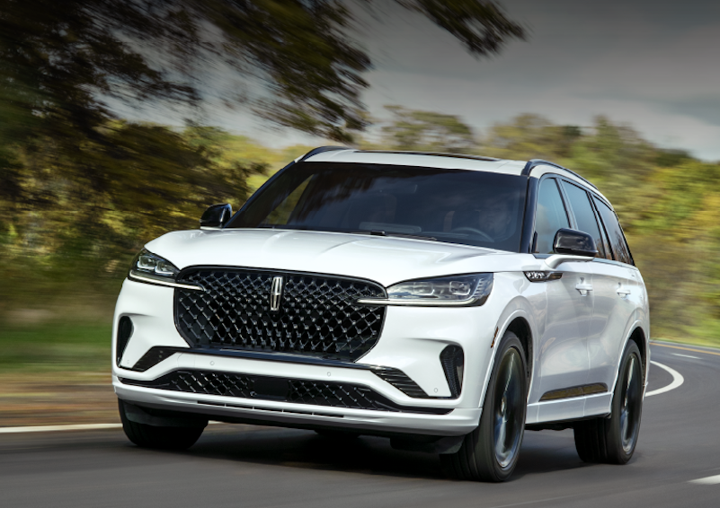 The 2025 Lincoln Aviator speeding down a road with its powerful engine
