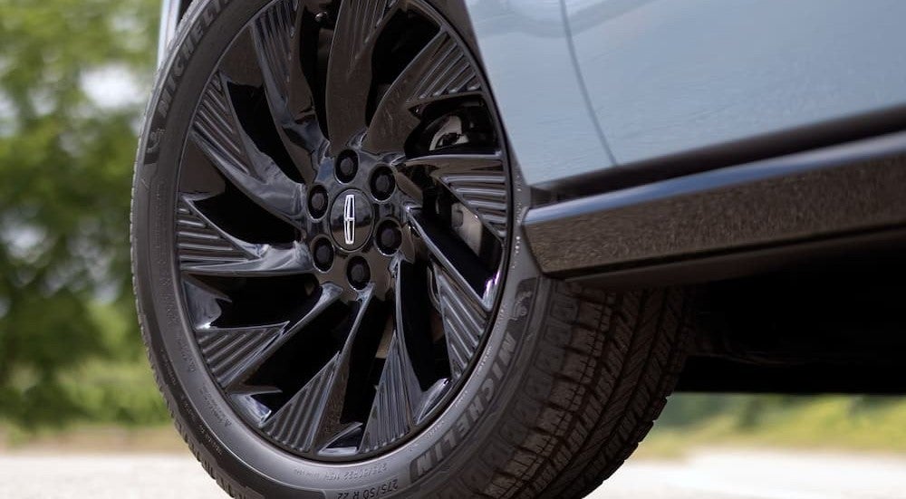 A wheel on a blue 2027 Lincoln Navigator.