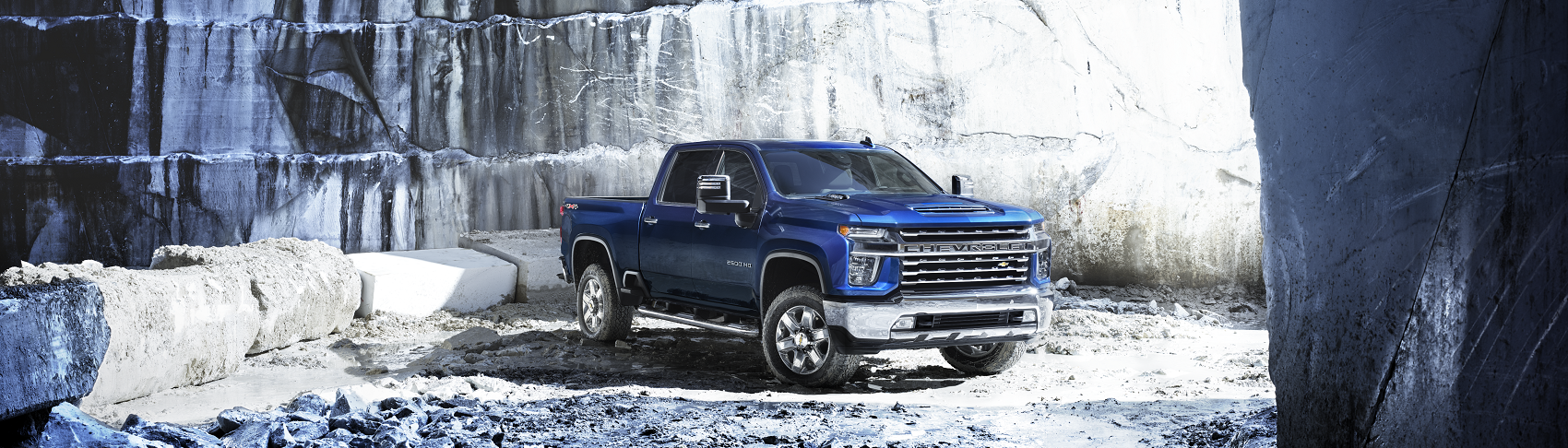 Blue Chevy Silverado parked in snow