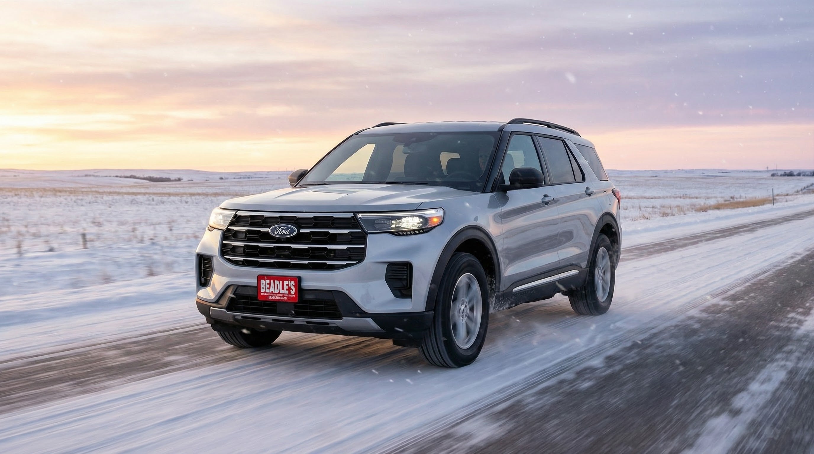 2026 Ford Explorer driving on a snowy South Dakota highway at sunset, Beadle Ford in Bowdle