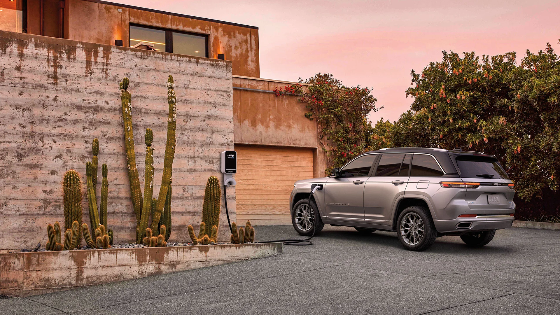 The Jeep Grand Cherokee charging in a driveway