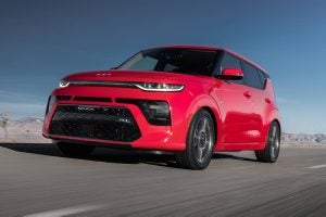 A red 2022 Kia Soul Turbo driving on the highway.