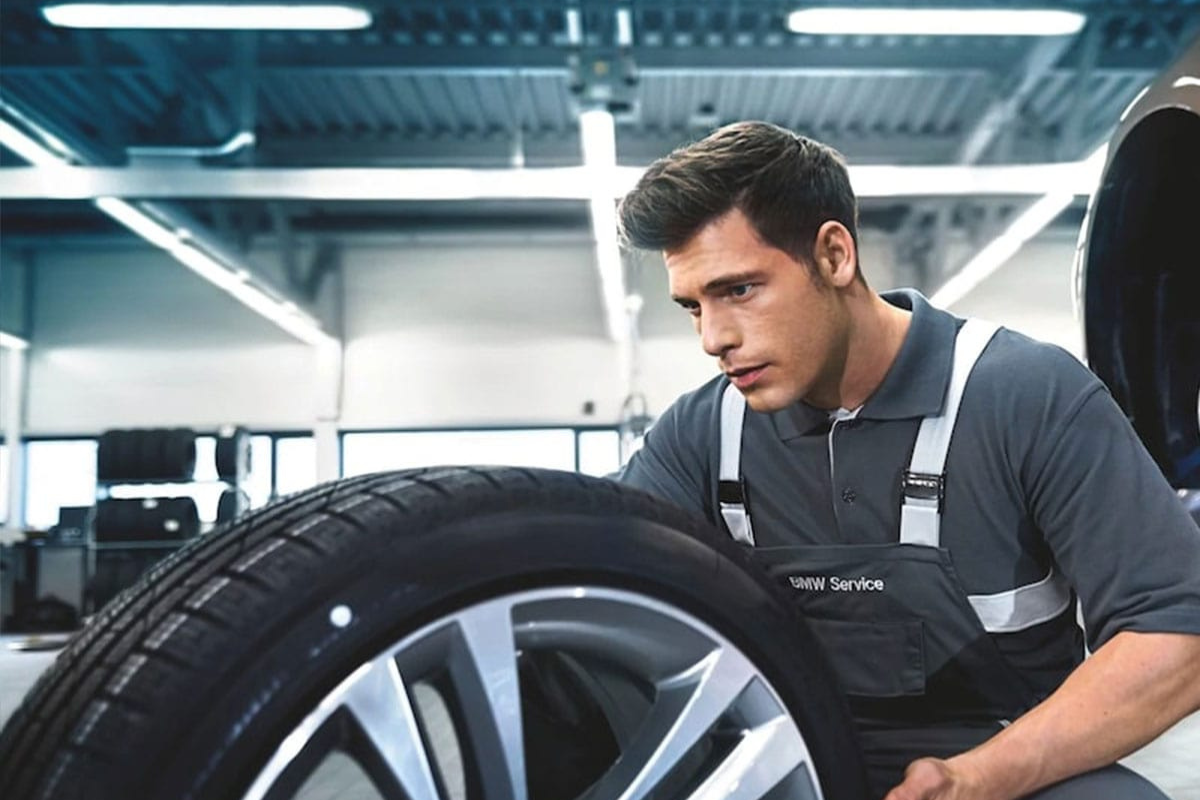 BMW Tire Inspection at BMW of Grand Blanc BMW-trained technician inspecting tire tread at BMW of Grand Blanc