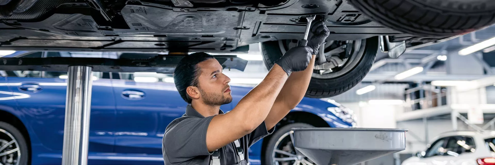 BMW-trained technician performing maintenance on a BMW