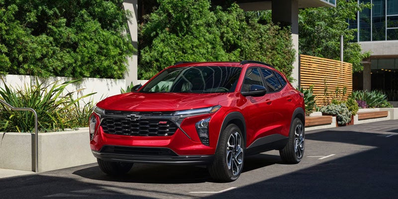 A red Chevrolet Trax parked in an urban setting.