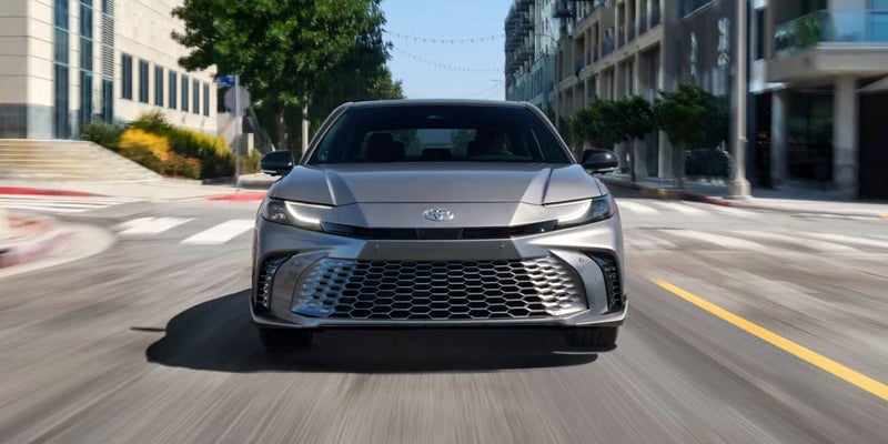 2025 Toyota Vehicle front view driving in city street
