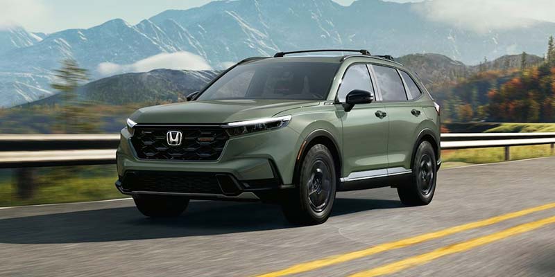 2026 Honda CR-V Hybrid driving on scenic mountain road
