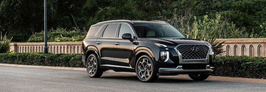 Black 2021 Hyundai Palisade Front Exterior on City Street at Dusk