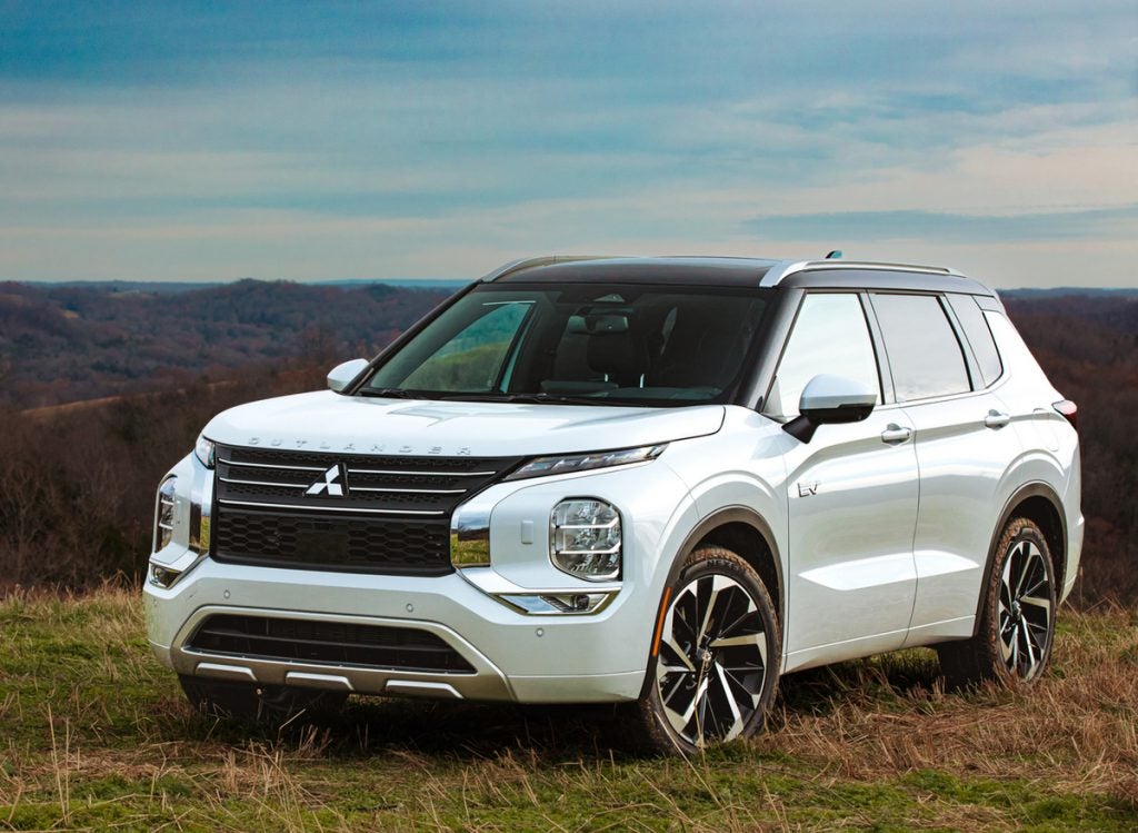 A white Mitsubishi Outlander PHEV vehicle.