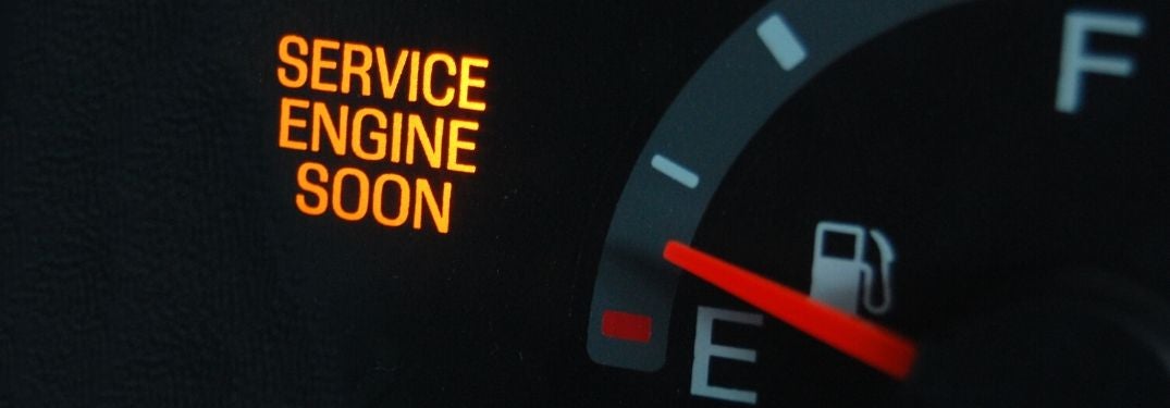Close Up of a Vehicle Instrument Display with Service Engine Soon Light