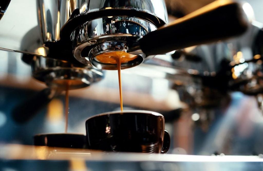Upclose of coffee being brewed and dripping into a cup.