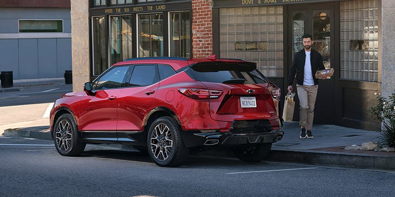 A red Chevrolet SUV parked outside a store