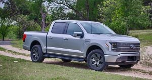 A photo of the 2022 Ford F-150 lightning riding on a gravel road