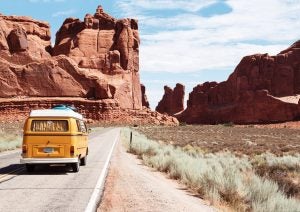 A photo of a bus driving towards a national monument