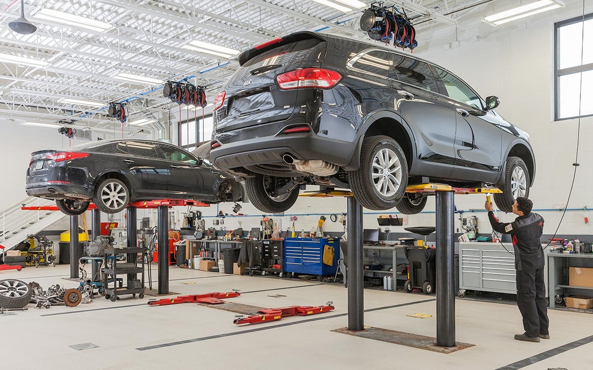Service advisors performing a brake repair on a Kia vehicle