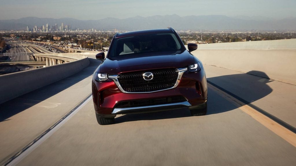 a red suv driving towards the camera