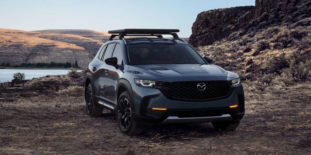a dark grey suv parked in a rocky area