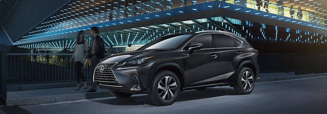 Black 2020 Lexus NX and Couple Next to Glass Modern Building