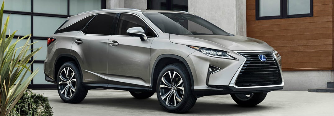 Silver 2019 Lexus RX 350l is parked in a driveway.